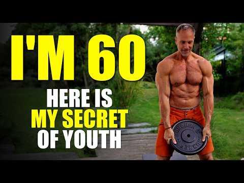 Energetic 60-year-old man jogging in a park at sunrise, wearing athletic gear, with a bright smile showing vitality and health